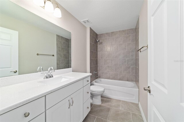 bathroom featuring toilet, tile patterned floors, vanity,  shower combination, and a textured ceiling