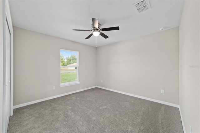 unfurnished room featuring ceiling fan, baseboards, carpet, and a smoke detector