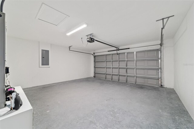 garage featuring a garage door opener and electric panel