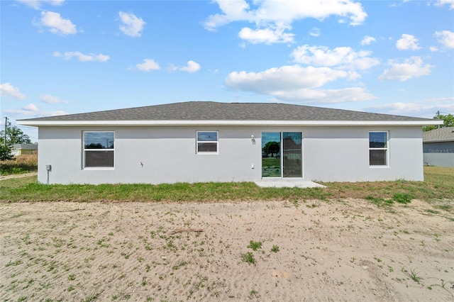 rear view of property with stucco siding