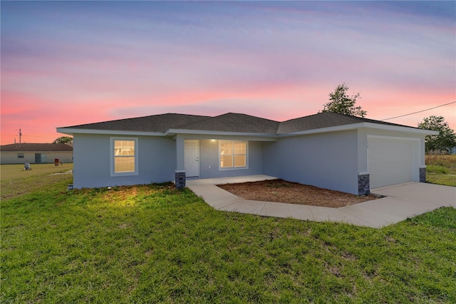 ranch-style house featuring an attached garage, stucco siding, driveway, and a front lawn