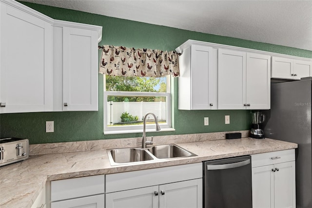 kitchen with a sink, white cabinets, and dishwasher