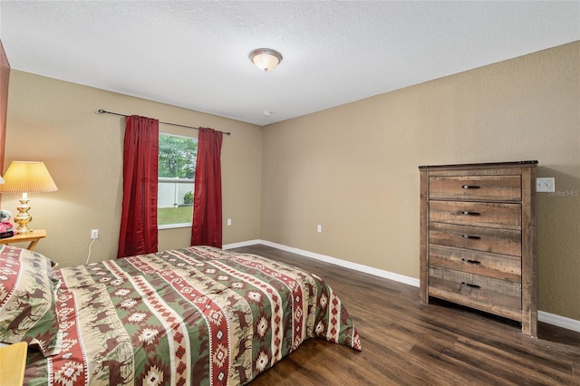 bedroom featuring baseboards and wood finished floors