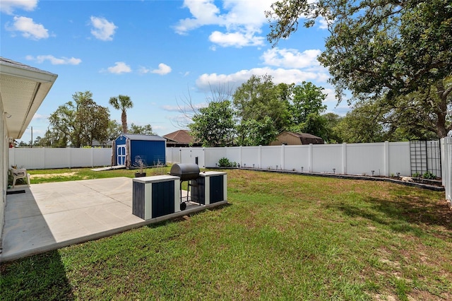 view of yard featuring an outbuilding, a patio area, a fenced backyard, and a storage shed