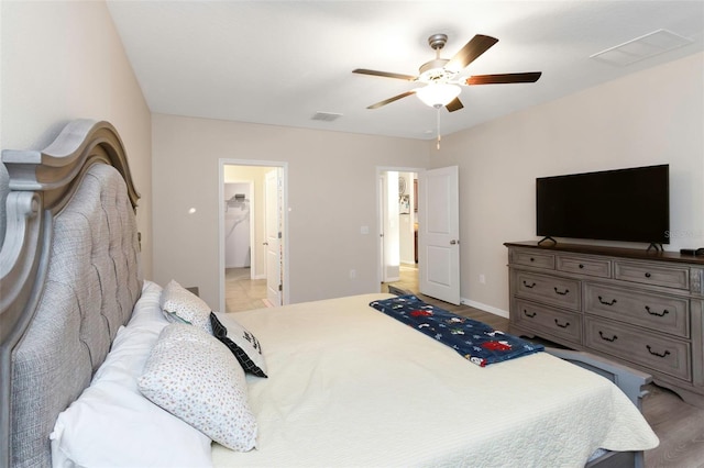 bedroom featuring ceiling fan, visible vents, and baseboards