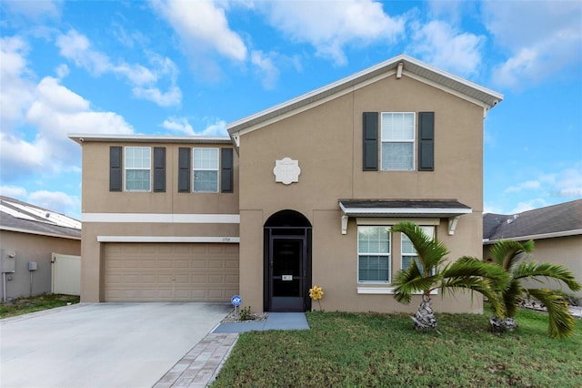 traditional-style house with an attached garage, driveway, and stucco siding
