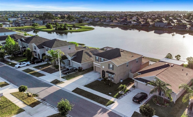 birds eye view of property featuring a water view and a residential view