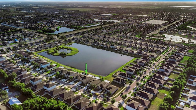 drone / aerial view with a water view and a residential view