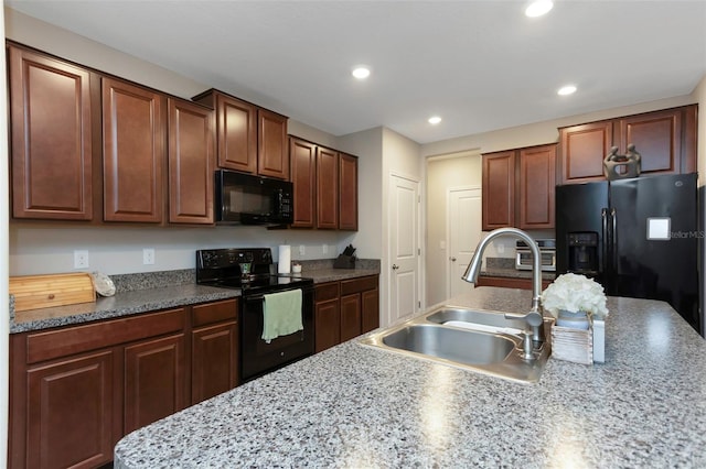 kitchen with light countertops, recessed lighting, a sink, and black appliances