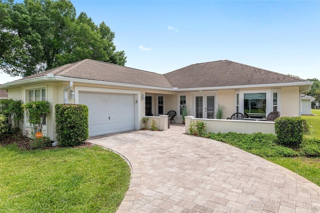 6858 SW 111th Loop, Ocala, FL 34476 - ranch-style house featuring french doors, stucco siding, an attached garage, and decorative driveway