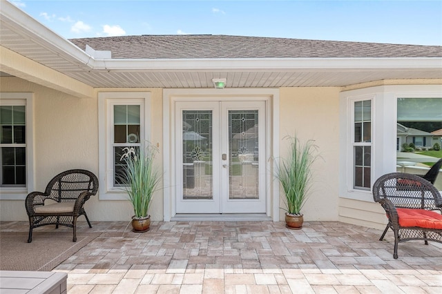 6858 SW 111th Loop, Ocala, FL 34476 - entrance to property with a patio, french doors, roof with shingles, and stucco siding