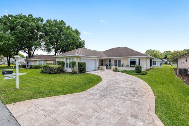 6858 SW 111th Loop, Ocala, FL 34476 - ranch-style house featuring decorative driveway, cooling unit, a front yard, and a garage