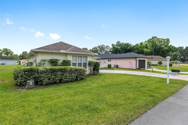 6858 SW 111th Loop, Ocala, FL 34476 - view of front facade with curved driveway, stucco siding, and a front yard