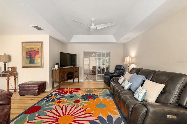 6858 SW 111th Loop, Ocala, FL 34476 - living area featuring visible vents, wood finished floors, baseboards, ceiling fan, and a tray ceiling