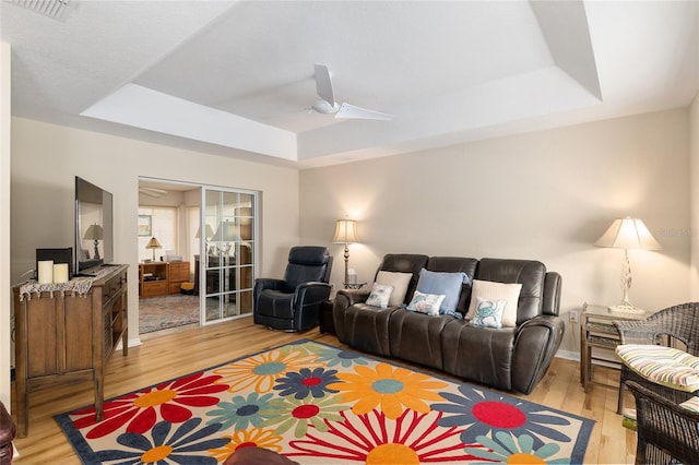 6858 SW 111th Loop, Ocala, FL 34476 - living area featuring ceiling fan, a tray ceiling, light wood finished floors, and visible vents