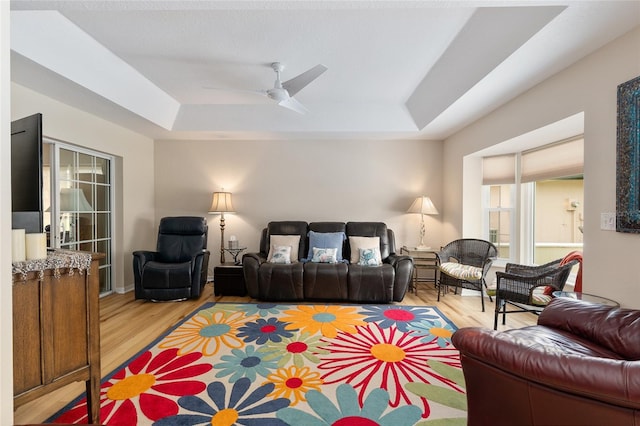 6858 SW 111th Loop, Ocala, FL 34476 - living area featuring a raised ceiling, a ceiling fan, and light wood-style flooring