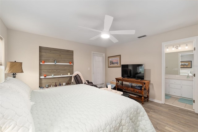 6858 SW 111th Loop, Ocala, FL 34476 - bedroom featuring ceiling fan, baseboards, ensuite bathroom, light wood-type flooring, and visible vents