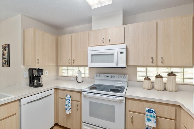 6858 SW 111th Loop, Ocala, FL 34476 - kitchen with white appliances, light brown cabinetry, and light countertops