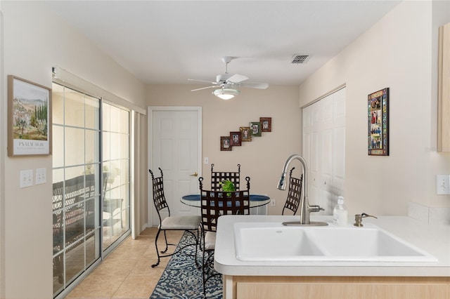 6858 SW 111th Loop, Ocala, FL 34476 - kitchen with a sink, light countertops, a ceiling fan, light tile patterned floors, and visible vents