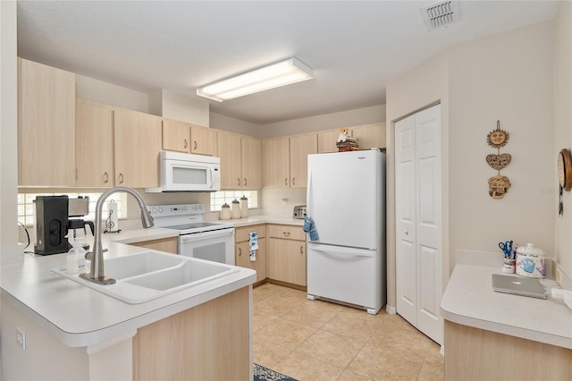 6858 SW 111th Loop, Ocala, FL 34476 - kitchen with a peninsula, light brown cabinetry, white appliances, and visible vents