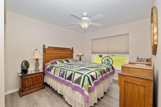 6858 SW 111th Loop, Ocala, FL 34476 - bedroom with baseboards, a ceiling fan, and light wood-style flooring