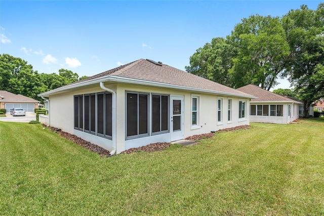 6858 SW 111th Loop, Ocala, FL 34476 - back of house with a yard, a shingled roof, a sunroom, and stucco siding