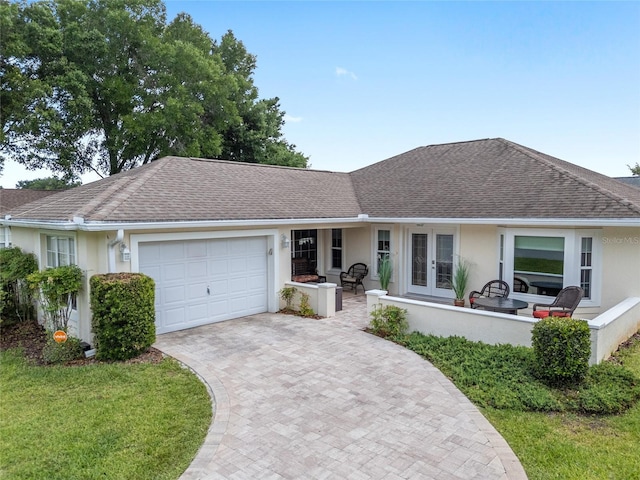 6858 SW 111th Loop, Ocala, FL 34476 - single story home with french doors, stucco siding, a shingled roof, and a garage