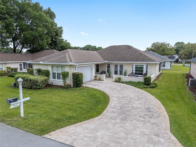 6858 SW 111th Loop, Ocala, FL 34476 - ranch-style home featuring an attached garage, decorative driveway, a front lawn, and stucco siding