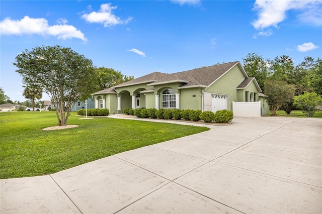 4966 SW 107th Loop, Ocala, FL 34476 - view of front of property with driveway, an attached garage, stucco siding, and a front yard