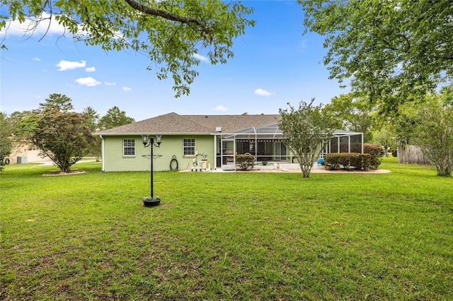 4966 SW 107th Loop, Ocala, FL 34476 - rear view of property with a yard, stucco siding, and a lanai