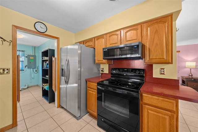 31 N Harrison St, Beverly Hills, FL 34465 - kitchen with stainless steel appliances, dark countertops, light tile patterned flooring, and electric panel