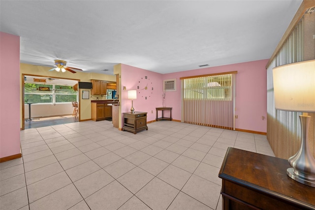 31 N Harrison St, Beverly Hills, FL 34465 - unfurnished living room with a ceiling fan, baseboards, light tile patterned floors, and a wall mounted air conditioner