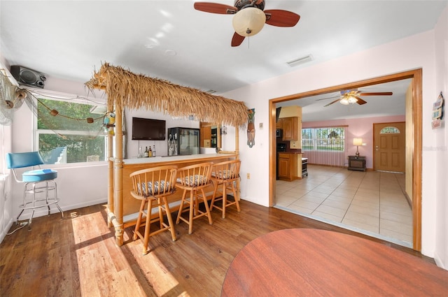 31 N Harrison St, Beverly Hills, FL 34465 - kitchen featuring ceiling fan, a breakfast bar, wood finished floors, and visible vents