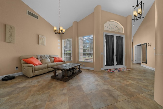 living room featuring baseboards, a chandelier, and visible vents