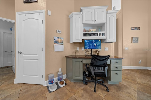 office area featuring baseboards and light tile patterned floors