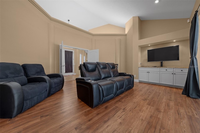 living area with high vaulted ceiling and wood finished floors