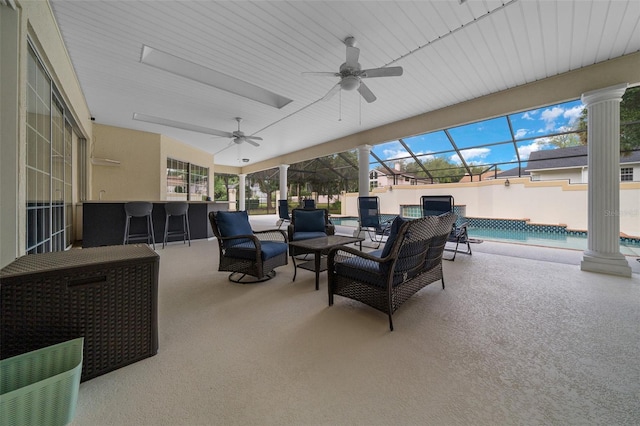 view of patio with a fenced in pool, a ceiling fan, glass enclosure, and outdoor dry bar
