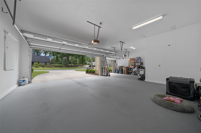 garage with baseboards and a garage door opener