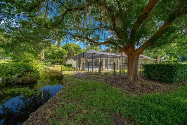 view of yard featuring a water view and fence