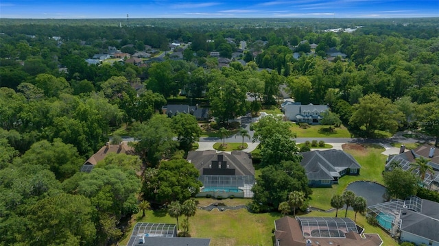 drone / aerial view with a residential view and a view of trees