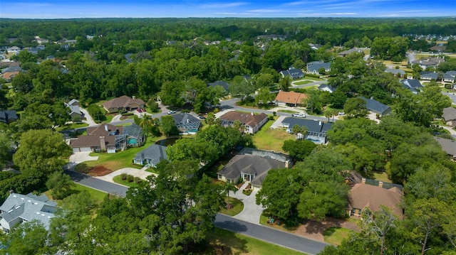 drone / aerial view featuring a residential view and a forest view