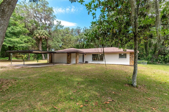 1406 SE Wacahoota Rd, Micanopy, FL 32667 - view of front facade with an attached garage, stucco siding, a front lawn, and concrete driveway