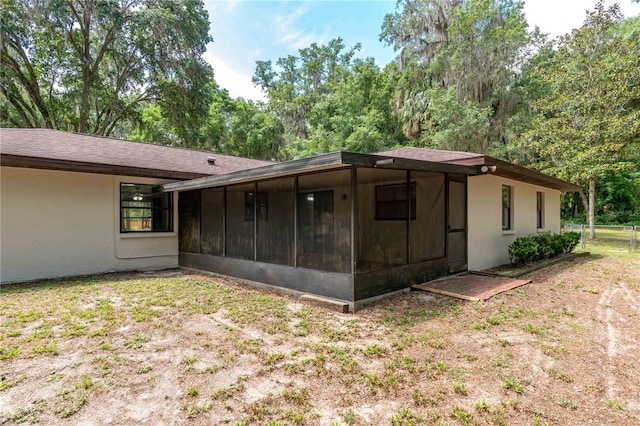 1406 SE Wacahoota Rd, Micanopy, FL 32667 - back of house featuring a sunroom and stucco siding