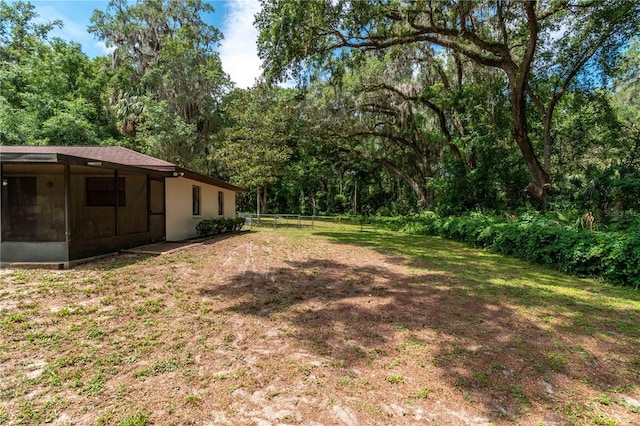 1406 SE Wacahoota Rd, Micanopy, FL 32667 - view of yard with a sunroom and a wooded view