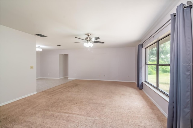 1406 SE Wacahoota Rd, Micanopy, FL 32667 - spare room featuring light carpet, a ceiling fan, and baseboards