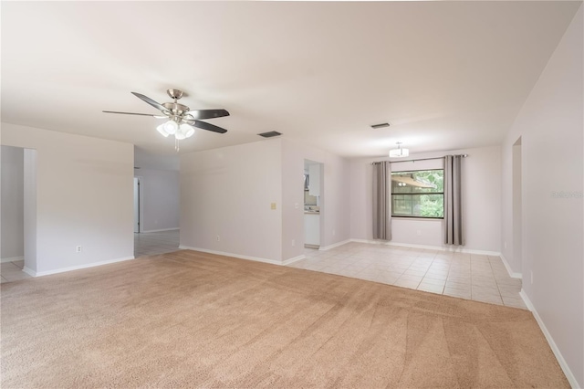 1406 SE Wacahoota Rd, Micanopy, FL 32667 - empty room featuring light carpet, ceiling fan, light tile patterned floors, and baseboards
