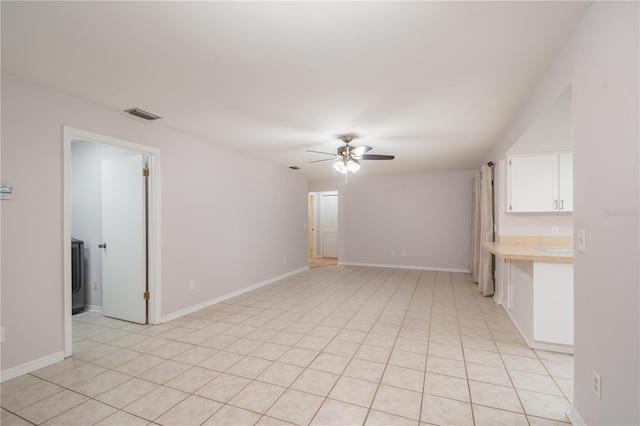 1406 SE Wacahoota Rd, Micanopy, FL 32667 - empty room featuring a ceiling fan, baseboards, and light tile patterned floors