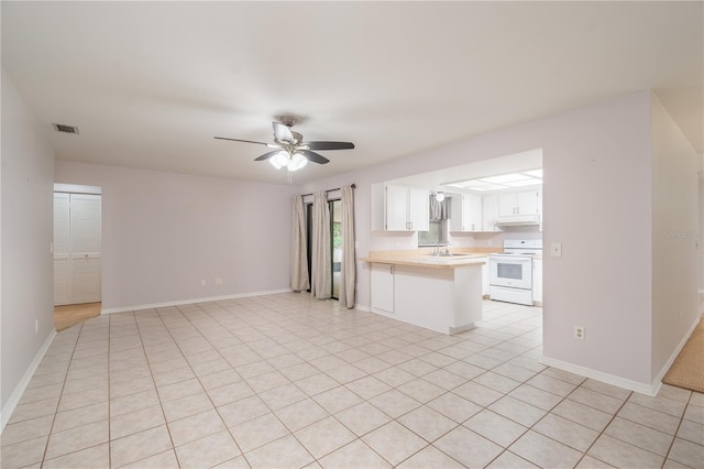1406 SE Wacahoota Rd, Micanopy, FL 32667 - unfurnished living room featuring a ceiling fan, a sink, baseboards, and light tile patterned floors