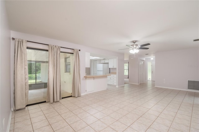 1406 SE Wacahoota Rd, Micanopy, FL 32667 - unfurnished living room with ceiling fan, baseboards, and light tile patterned floors
