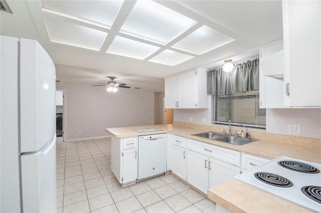 1406 SE Wacahoota Rd, Micanopy, FL 32667 - kitchen with a sink, white appliances, light tile patterned floors, a peninsula, and light countertops